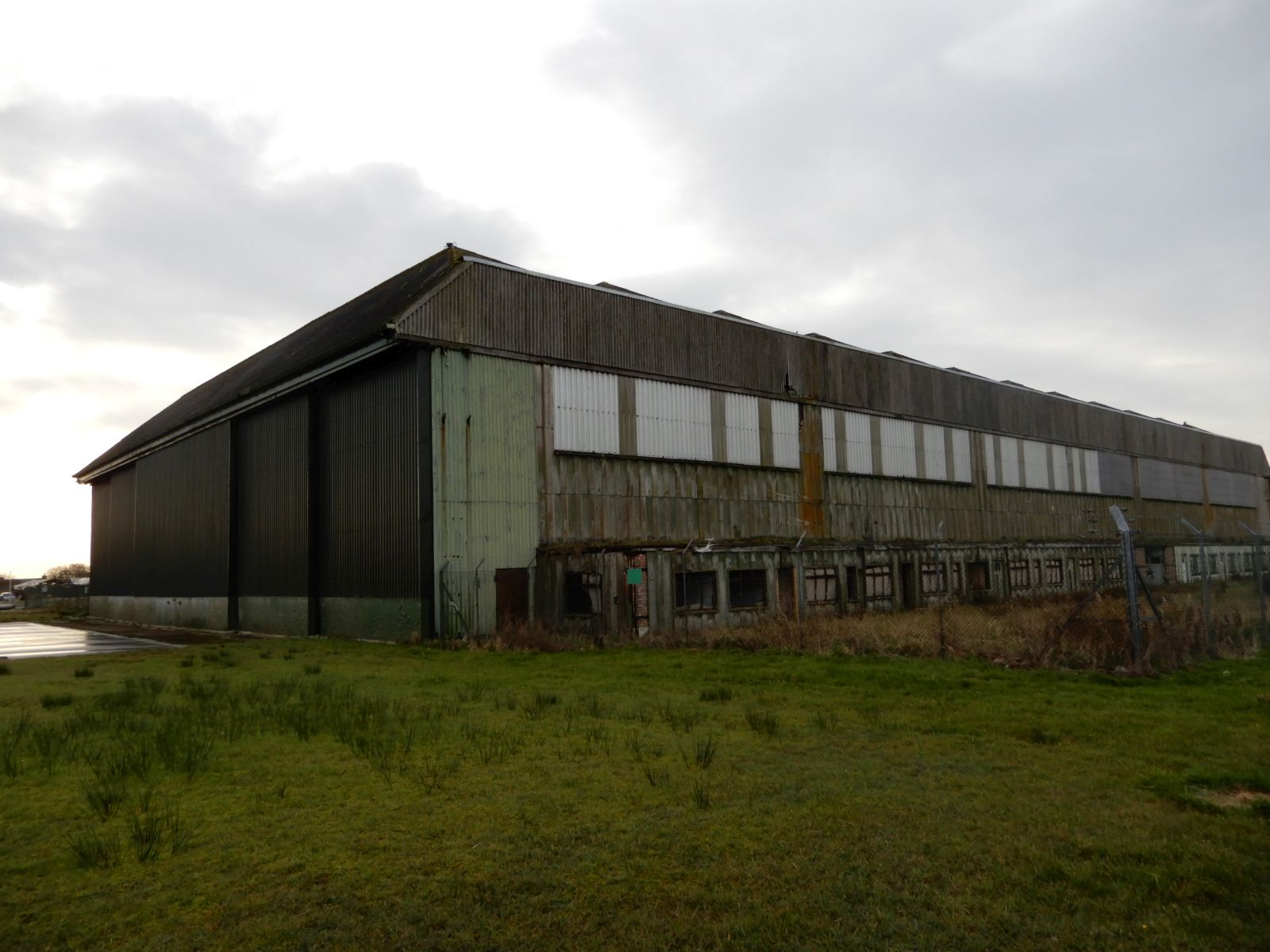 Letiště Wick (EGPC), druhoválečné hangáry pro bombardéry Lancaster. Ty malé budovy podél hangáru jsou márnice, kde se ukládali oběti po bombardování.